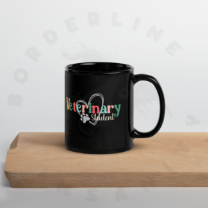 an 11oz black ceramic veterinary student mug sitting on a cutting board