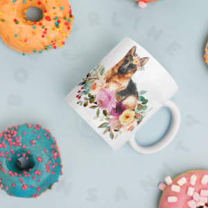 german shepherd in flowers mug lying on a blue table surrounded by colorful donuts