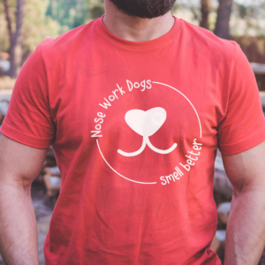 Heather red t-shirt with white circular text reading "Nose Work Dogs Smell Better" surrounding a heart-shaped dog nose graphic