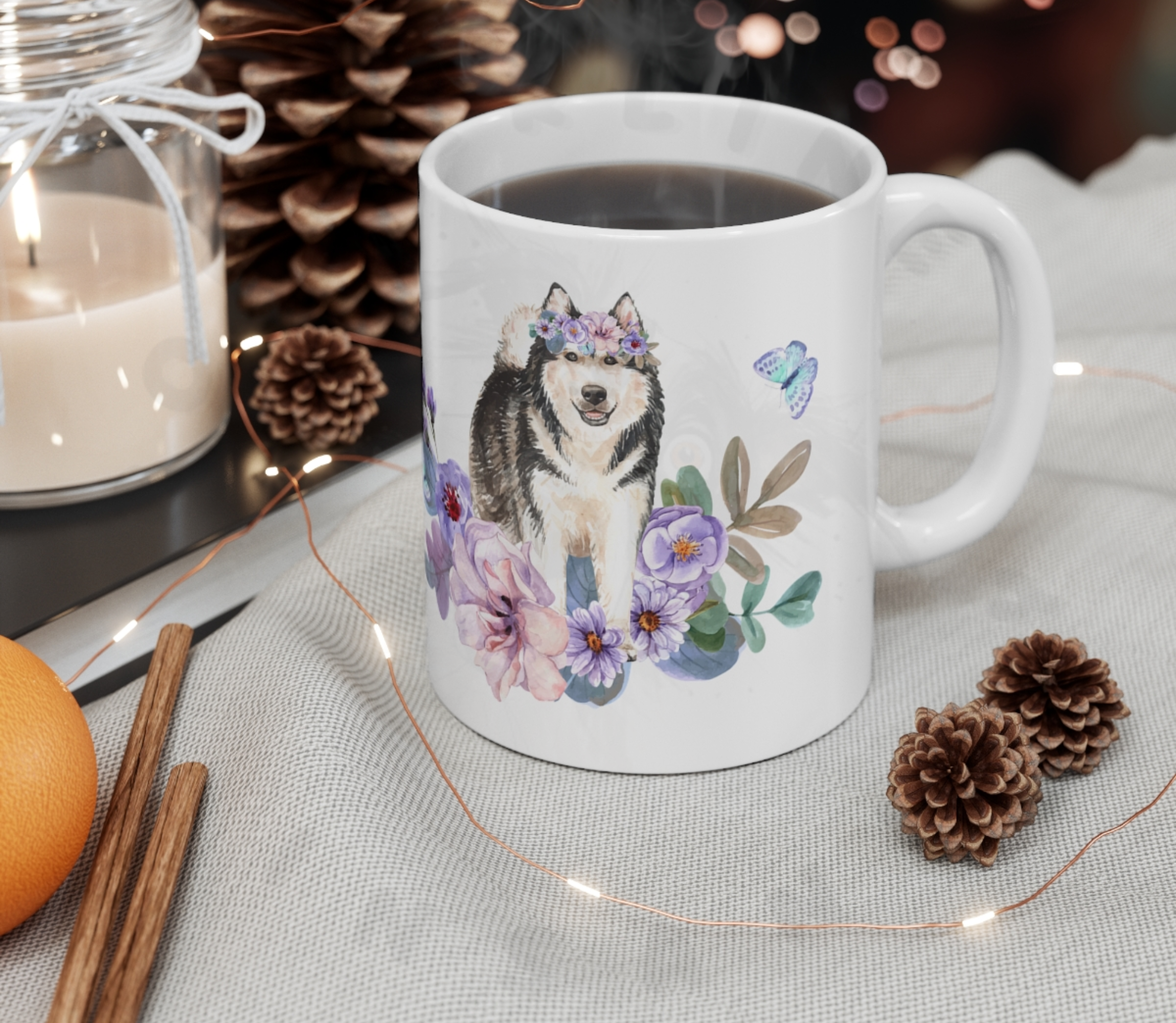 alaskan malamute mug in a christmas setting with pine cones and a candle