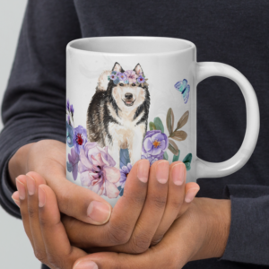 hands holding an alaskan malamute in flowers mug