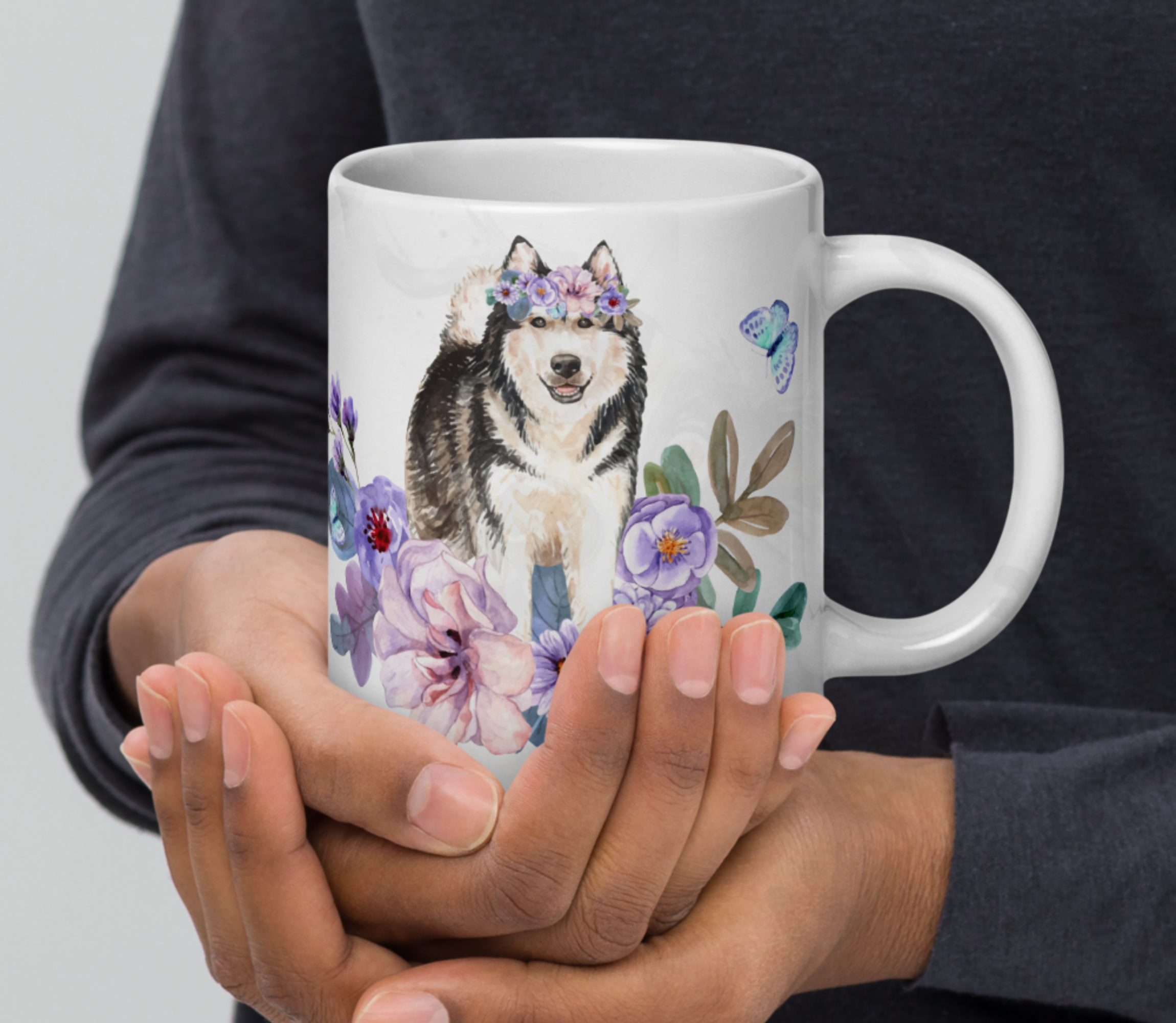 hands holding an alaskan malamute in flowers mug