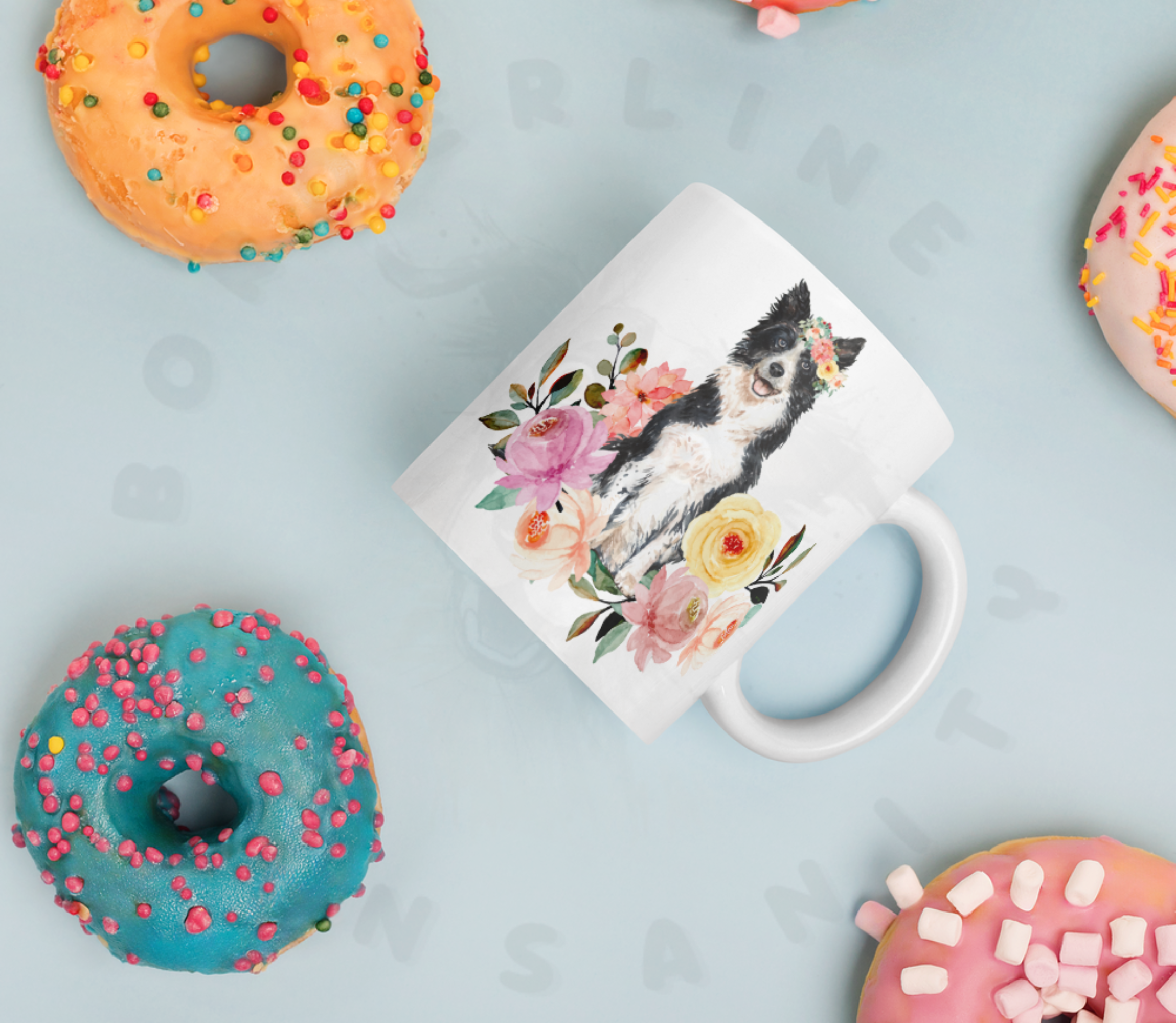 Border collie in flowers mug lying among colorful donuts