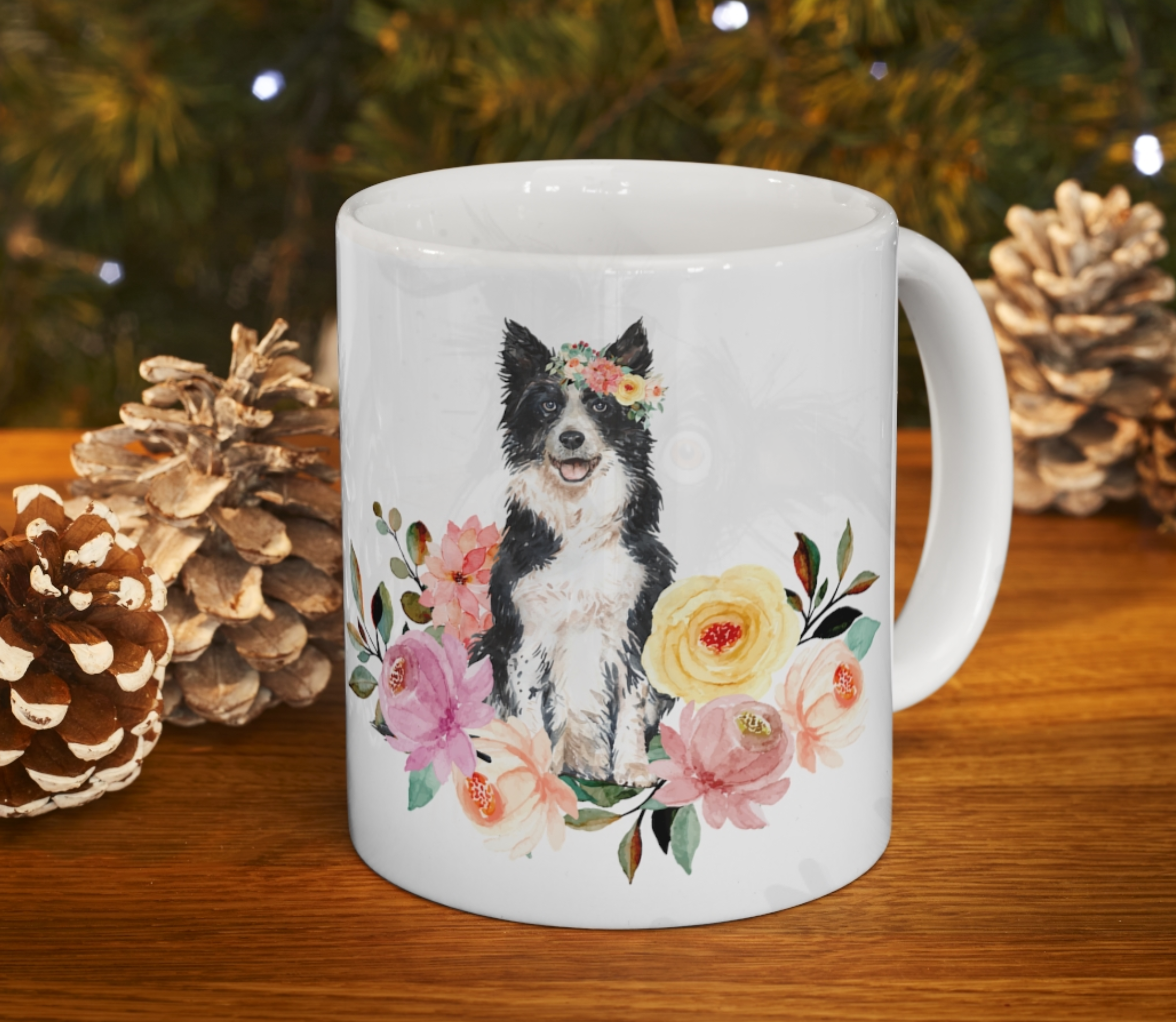 border collie in flowers mug in front of a christmas background with gold pine cones