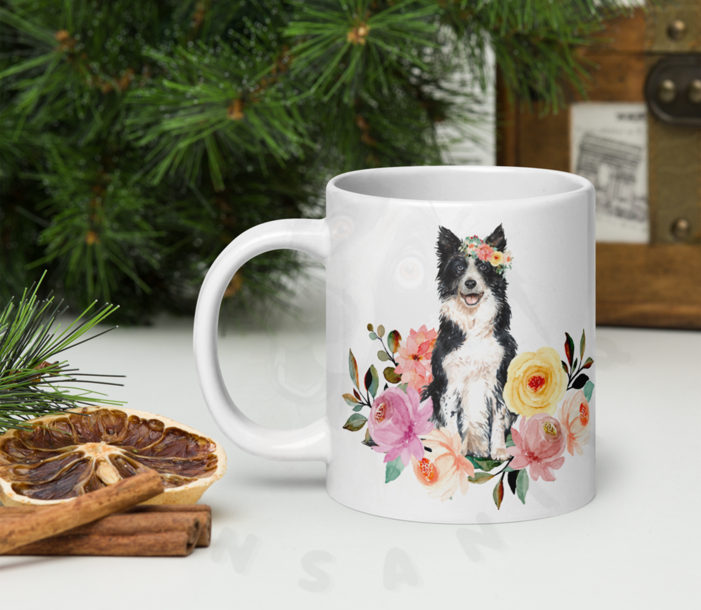 border collie in flowers mug in front of christmas greenery