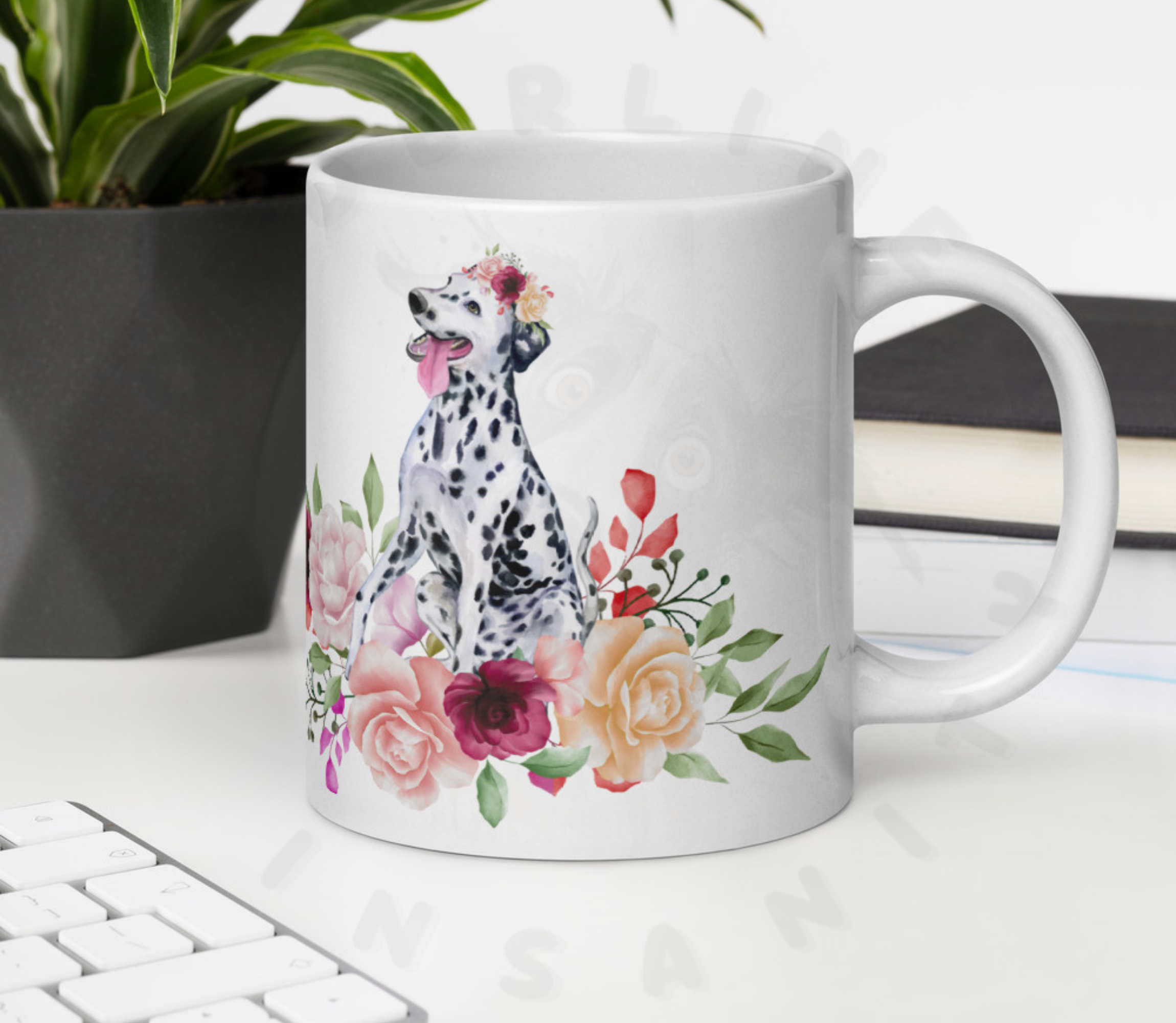 dalmatian in flowers mug on a desk in front of a potted plant