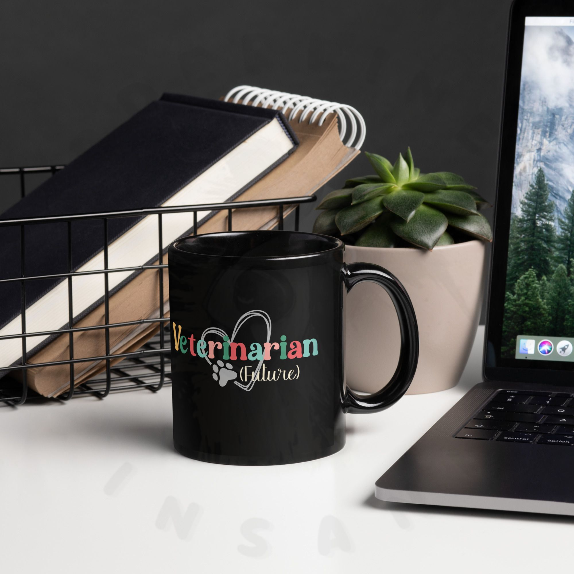 11oz black ceramic future veterinarian mug on a desk in front of books next to a laptop
