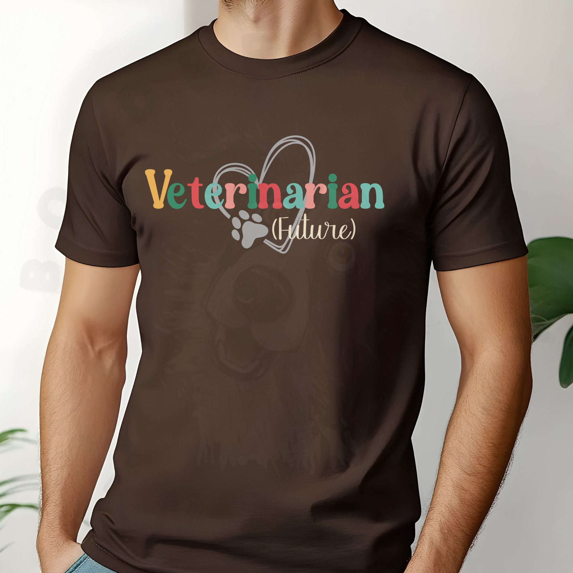 a man standing in front of a white background with plants wearing a brown future veterinarian tee with a heart and paw print