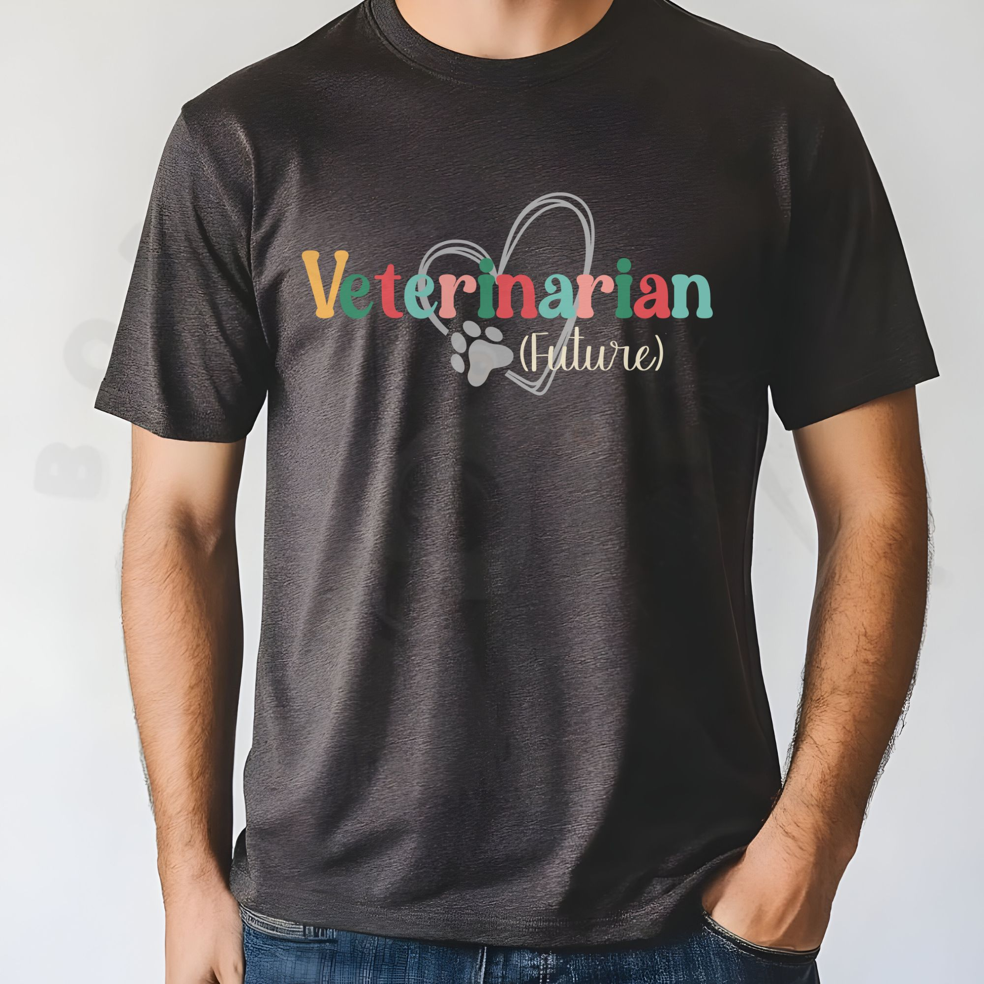 a man standing in front of a white background wearing a dark gray heather future veterinarian tee with a heart and paw print