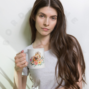 A woman holding a Pekingese floral ceramic mug with yellow and coral watercolor flowers
