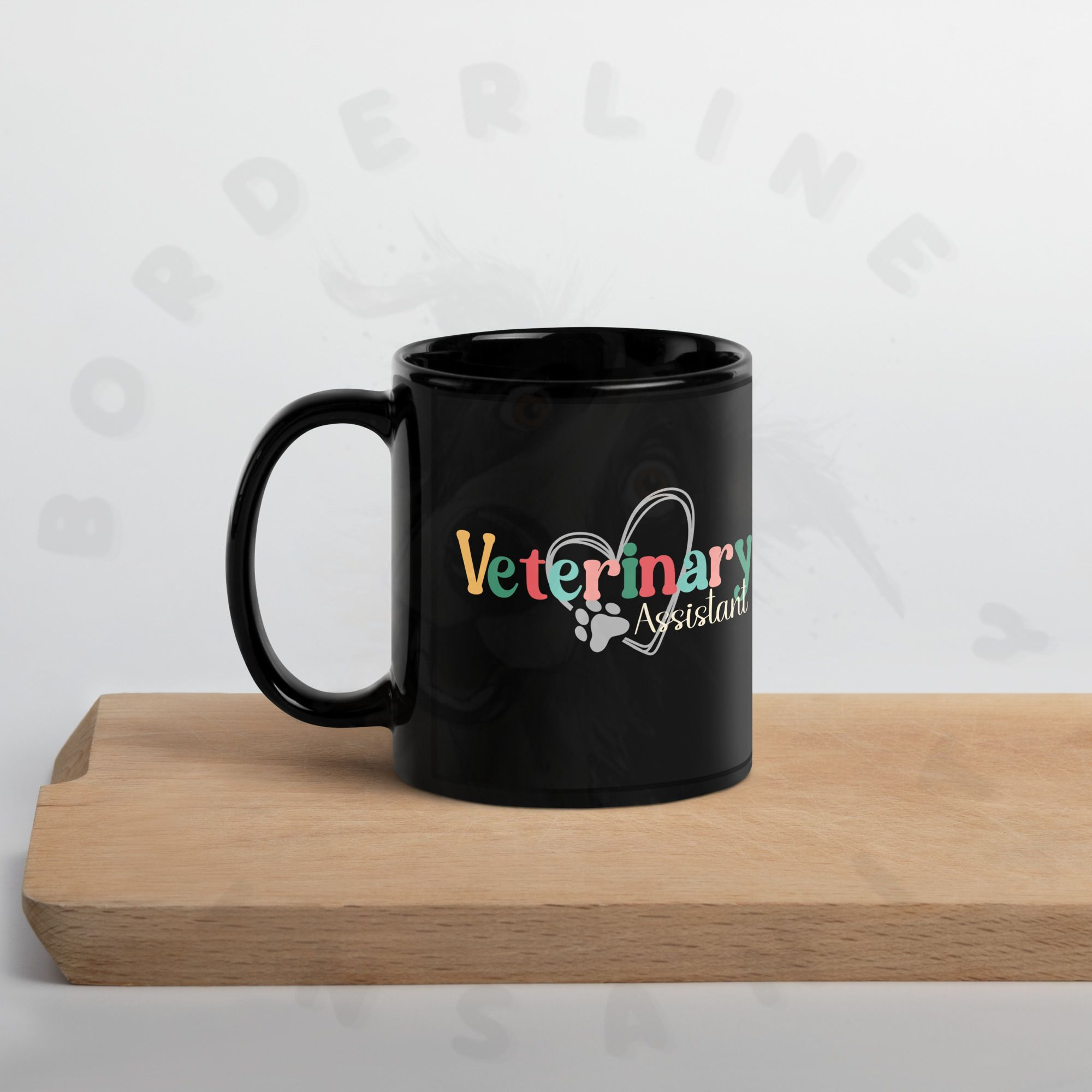 11oz veterinary assistant black ceramic mug sitting on a cutting board