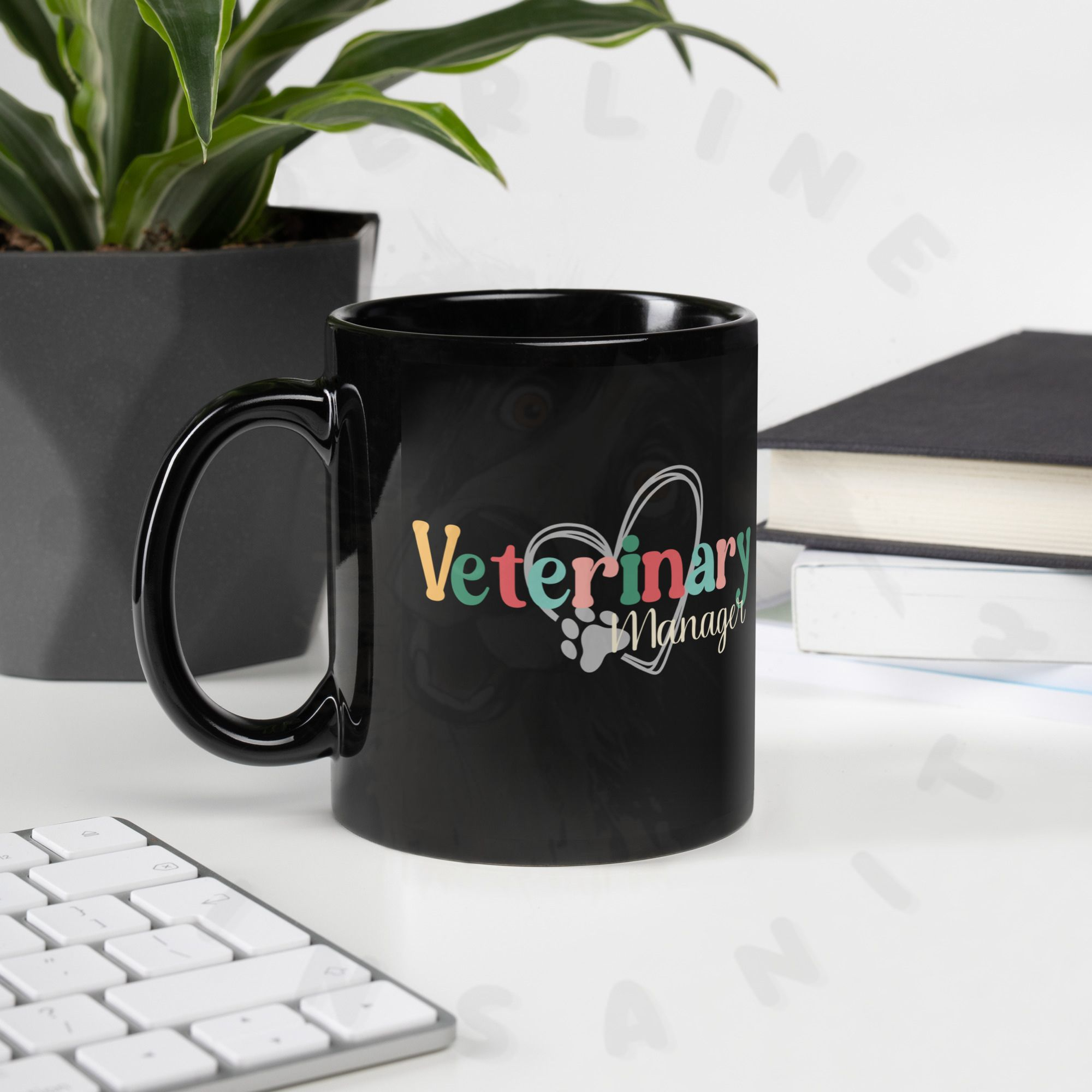 11oz black ceramic veterinary manager mug on a desk with a plant and a keyboard