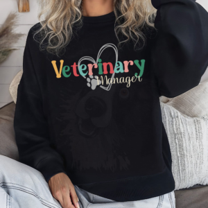 a woman in jeans wearing a black sweatshirt with a colorful veterinary manager design with a heart and pawprint
