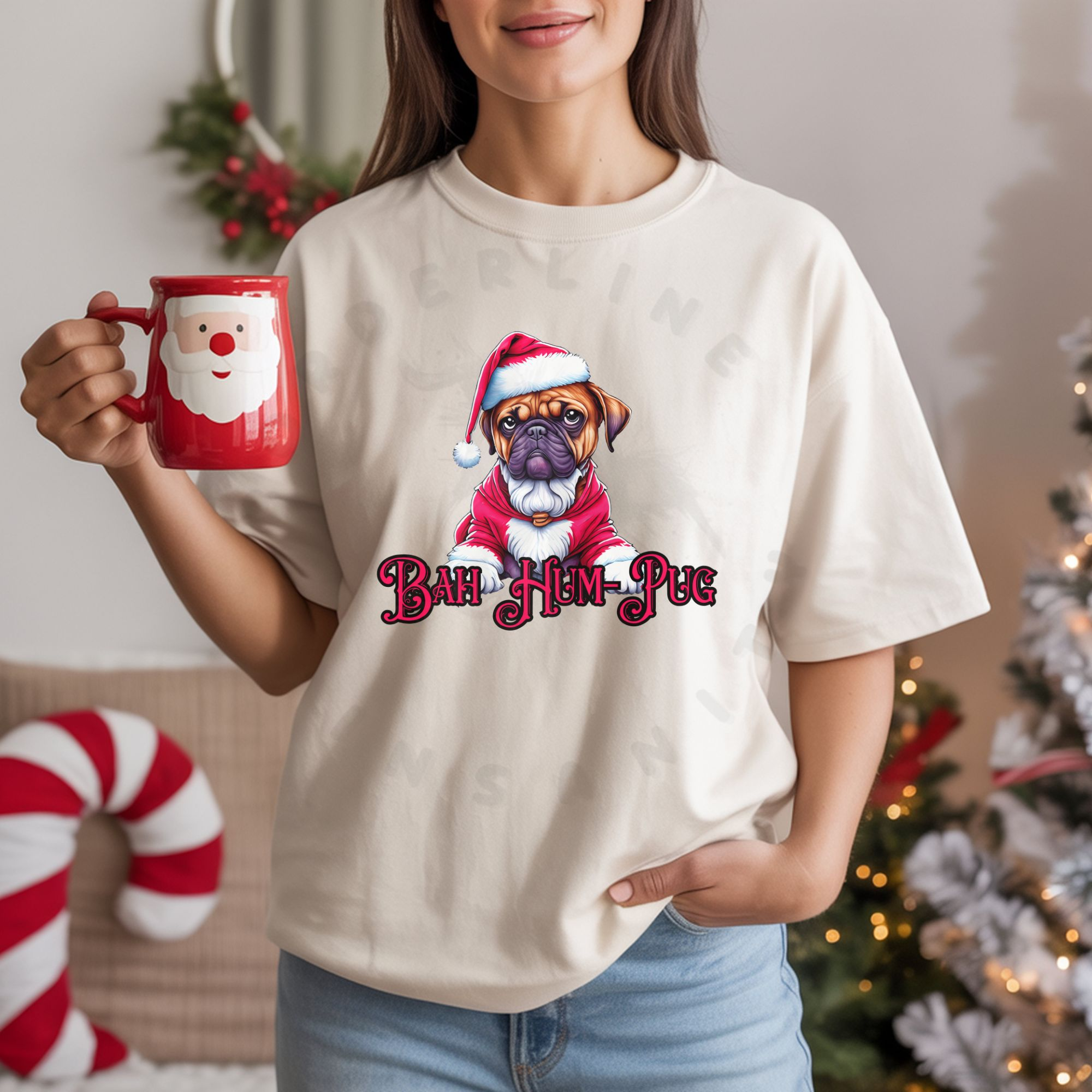 A woman holding a santa mug in a room full of christmas decorations wearing an ivory (natural) t-shirt that says bah hum-pug below a graphic of a grumpy pug wearing a santa suit
