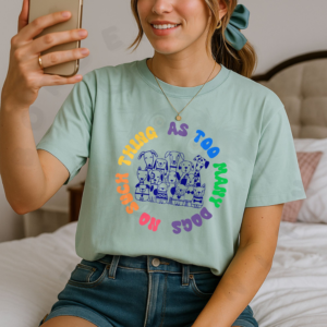 Heather prism dusty blue Bella + Canvas 3001 featuring a group of hand drawn dogs surrounded by rainbow text that says No Such Thing As Too Many Dogs, mockup on male model