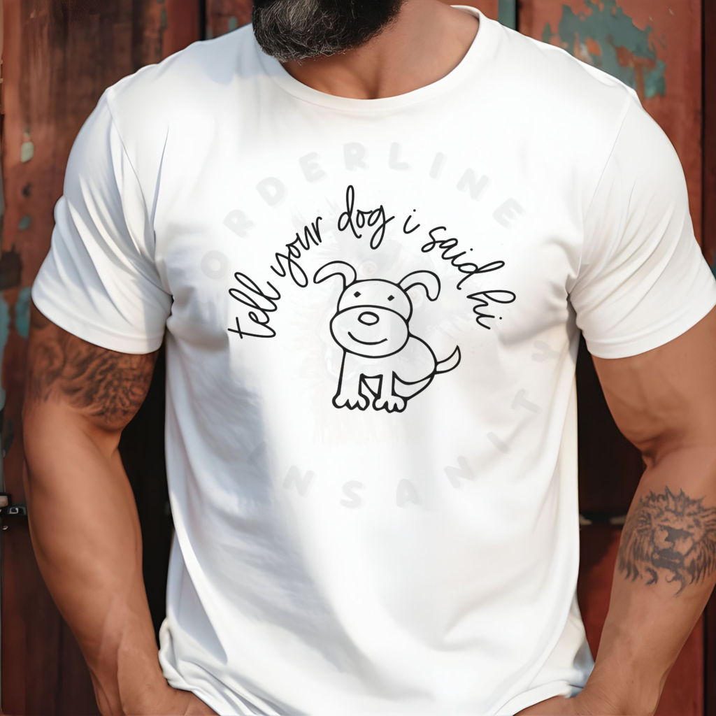 a man leaning against a wall wearing a white tee that says tell your dog i said hi with a hand-drawn style dog graphic