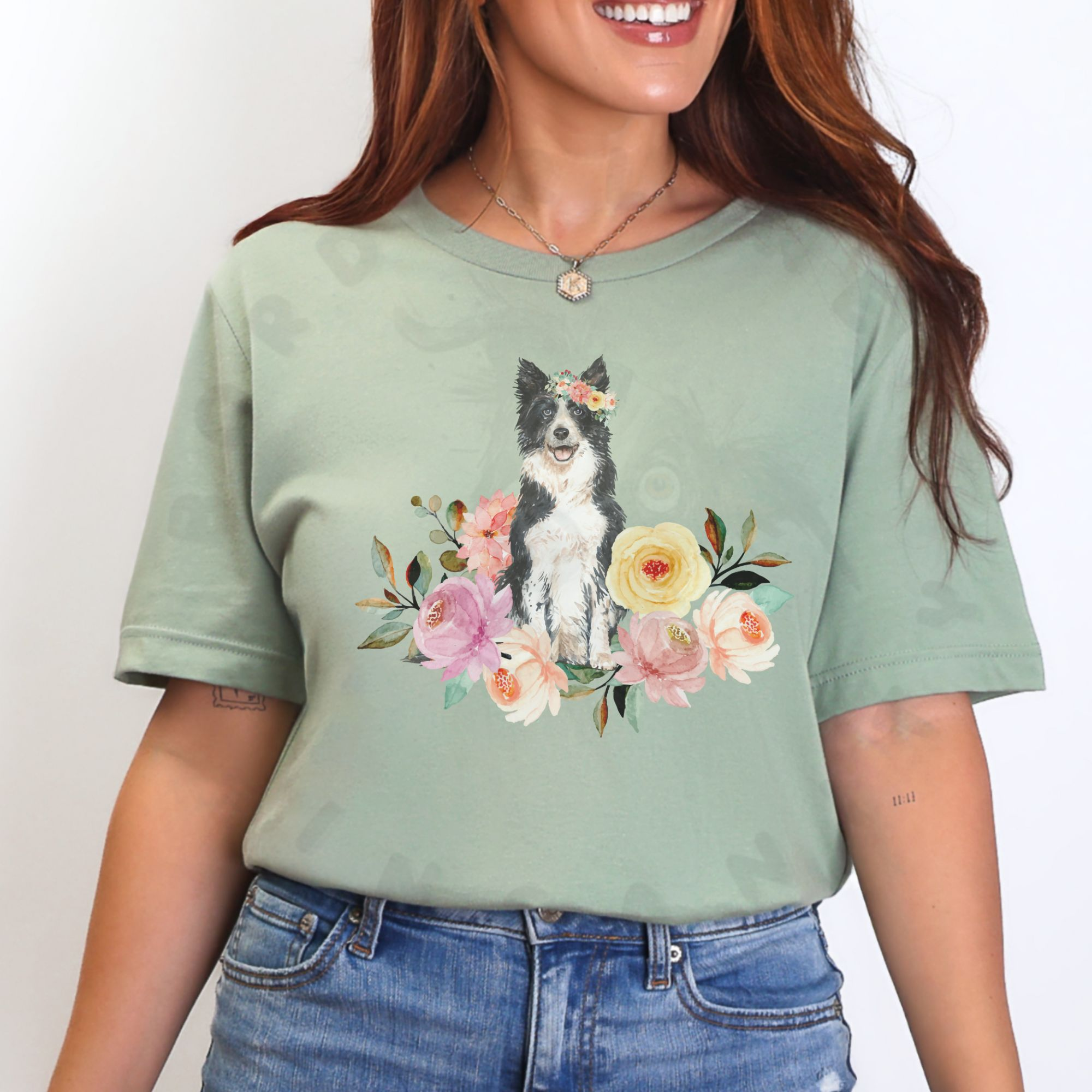 a woman standing in front of a white background wearing a sage green border collie in flowers tee