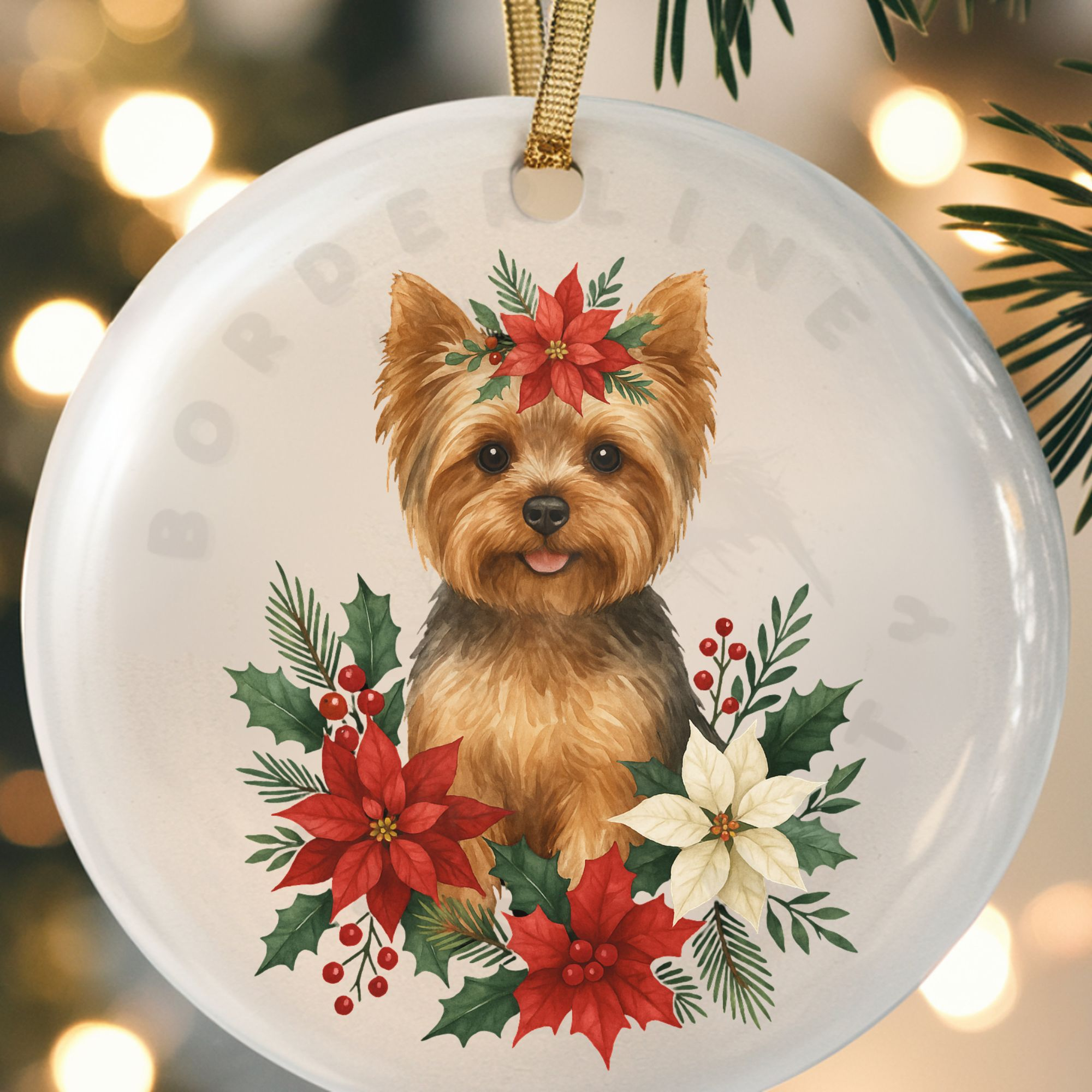 close up of a round ceramic ornament with a graphic of a yorkie surrounded by christmas flowers and greenery