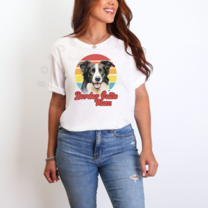 a woman standing in front of a white background wearing a white tee with a retro sunset design with a border collie that says border collie mom