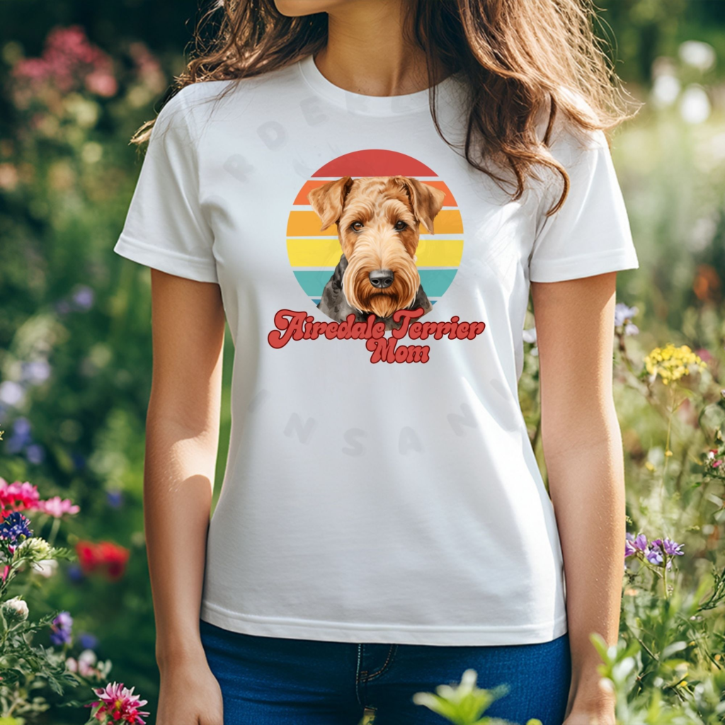 a woman wearing a white tee featuring a retro sunset graphic and an airedale terrier, with the words airedale terrier mom in retro script