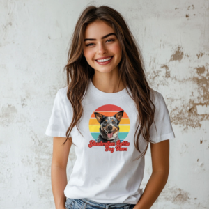 a woman wearing a white tee with a retro sunset design featuring an australian cattle dog and the words australian cattle dog mom in retro script