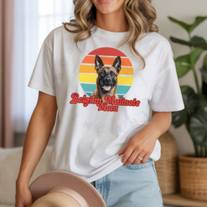 a woman wearing a white tee featuring a retro sunset design with a belgian malinois and the words belgian malinois mom in retro script