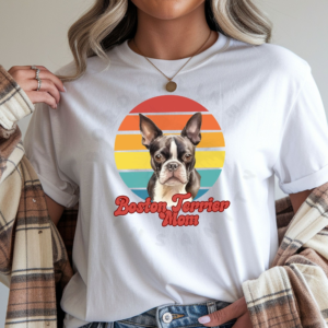 a woman wearing a white tee featuring a retro sunset design with a boston terrier and the words boston terrier mom in retro script