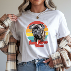 a woman wearing a white tee featuring a retro sunset design with a cane corso and the words cane corso mom in retro script