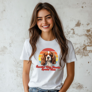 a woman wearing a white tee featuring a retro sunset design with a cavalier king charles spaniel and the words cavalier king charles spaniel mom in retro script