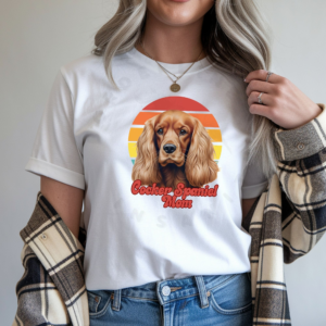 a woman wearing a white tee featuring a retro sunset design and a cocker spaniel with the words cocker spaniel mom