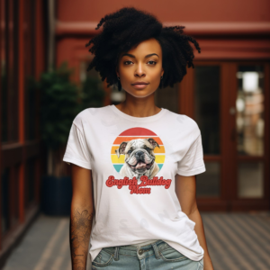 a woman wearing a white tee featuring a retro sunset design with an english bulldog and the words english bulldog mom in retro script