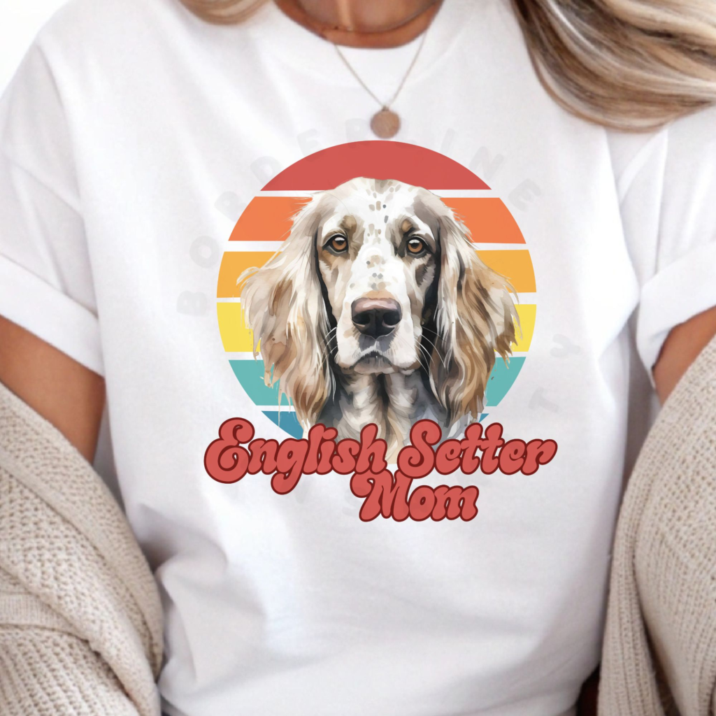 a woman wearing a white tee featuring a retro sunset design with an english setter and the words english setter mom in retro script