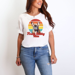 a woman wearing a white tee featuring a retro sunset design with a french bulldog and the words french bulldog mom in retro script