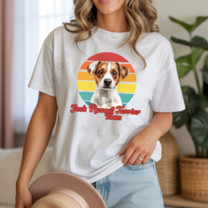 a woman wearing a white tee featuring a retro sunset design with a jack russell and the words jack russell mom in retro script