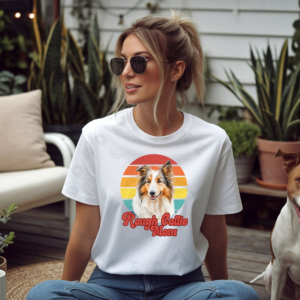 a woman wearing a white tee featuring a retro sunset design with a rough collie and the words rough collie mom in retro script