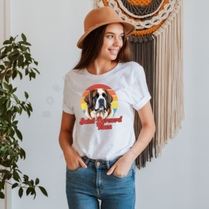 a woman wearing a white tee with a retro sunset design and a saint bernard with the words saint bernard mom in retro script
