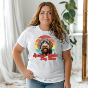 a woman wearing a white tee featuring a retro sunset design with a spanish water dog and the words spanish water dog mom in retro script