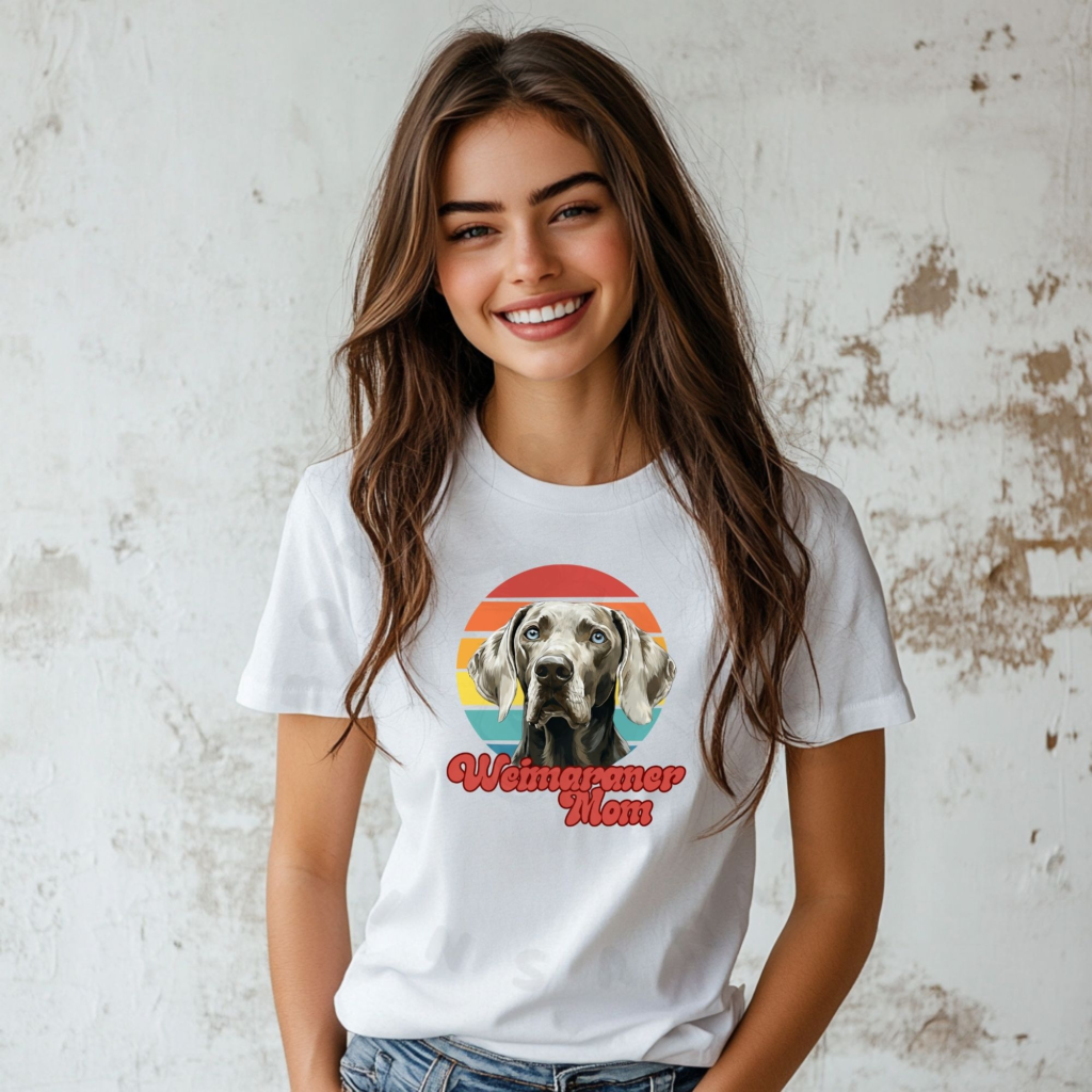 a woman wearing a white tee featuring a retro sunset design with a weimaraner and the words weimaraner mom in retro script