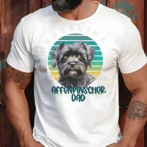 a bearded man standing with his hands in his pockets, wearing a white tee that affenpinscher dad with a retro sunset design and an affenpinscher