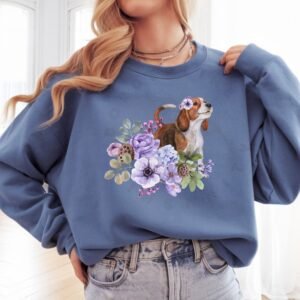 a woman wearing an indigo blue crewneck sweatshirt featuring an image of a beagle in watercolor flowers