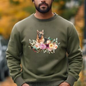 a man standing in a park in fall wearing a military green sweatshirt featuring an image of a german shepherd in watercolor flowers