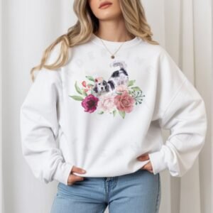 a woman wearing a white crewneck sweatshirt with a graphic of an english setter in watercolor flowers