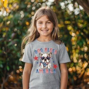 a girl wearing a sport grey tee featuring a graphic of a cartoon style bulldog wearing an American flag bandana with the words dog bless america in red and blue