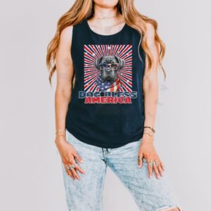 a woman wearing a navy tank with a patriotic background and an image of a cane corso in an american flag bandana and sunglasses that says dog bless america