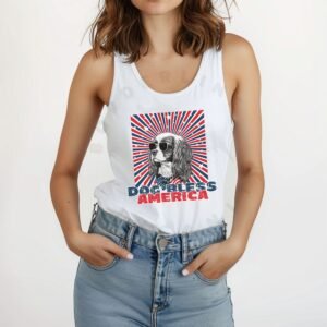 a woman wearing a white tank with a patriotic background and an image of a cavalier king charles spaniel in an american flag bandana and sunglasses that says dog bless america