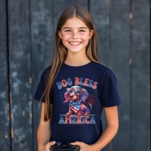 a girl wearing a navy tee featuring a graphic of a cartoon style dachshund wearing an american flag bandana with the words dog bless america in red and blue