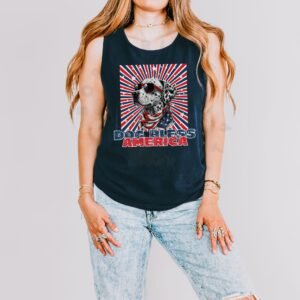 a woman wearing a navy tank with a patriotic background and an image of a dalmatian in an american flag bandana and sunglasses that says dog bless america
