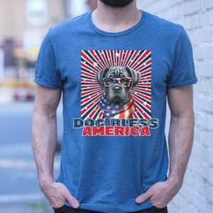 a man standing near a brick wall wearing a heather true royal tee with a patriotic background and an image of a cane corso in an american flag bandana and sunglasses that says dog bless america