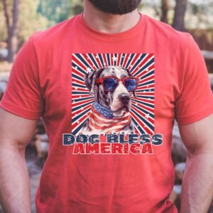 a man wearing a heather red tee with a patriotic background and an image of a great dane in an american flag bandana and sunglasses that says dog bless america
