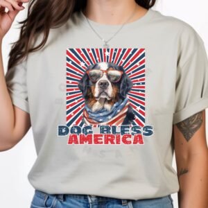 a woman wearing a silver tee with a patriotic background and an image of a bernese mountain dog in an american flag bandana and sunglasses that says dog bless america